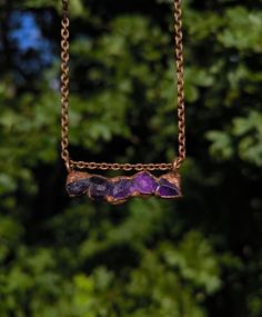 Great necklace with five raw amethyst crystals, which were set in copper using electroforming. The copper was then polished and sealed to prevent potential oxidation and discoloration. Width of pendant: 4.3 cm Length of pendant: 1.5 cm Each piece of jewelry is made by me with love and care in my small studio and is therefore unique. Each piece of jewelry is shipped in environmentally friendly gift packaging. Amethyst Pendant Necklace With Raw Stone, Amethyst Raw Stone Pendant Necklace, Amethyst Raw Stone Necklace For Healing, Hand Forged Purple Pendant Necklace, Purple Mineral Crystal Jewelry With Raw Stone, Purple Raw Stone Mineral Crystal Jewelry, Hand-forged Purple Pendant Necklace, Electroformed Amethyst Crystal Necklace As Gift, Purple Amethyst Necklace With Raw Stone