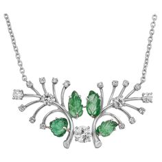 Wonderful 1960's carved bright green Emerald and diamond pendant. 4 carved leaf design emeralds set in a Platinum tree branch style setting with one Old European cut .55ct diamond, accented with 14 round Old European cut diamonds. 19.5 inch chain. The GIA has certified the emeralds natural, simple F1 enhancement which is low level clarity enhancement. 4 carved green Emeralds, approx. total weight 3.10cts, F1, GIA certificate #2171689458 1 old European cut diamond, approx. total weight .55cts, I, VS2 – SI1 14 round and old European cut diamonds, approx. total weight .81cts, I, VS – SI 950 Platinum Tested: Platinum Stamped: PT 950 Top to bottom: 21.51mm or .85 inch Width: 43.05mm or 1.70 inches Depth: 6.90mm 15.4 grams Length: 19.5 inches – Width: 1.60mm – Depth: 1.09mm Platinum Pendant, Gia Certificate, European Cut Diamonds, Tree Branch, Green Emerald, Gorgeous Jewelry, Emerald Diamond, Bright Green, Leaf Design