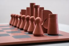 a set of chess pieces sitting on top of a wooden board