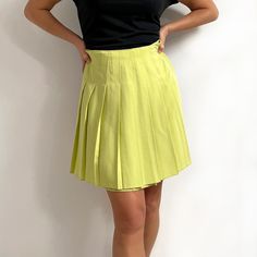 Gorgeous, bright vintage short pleated skirt in juicy lime green. It has wide, sharp pleats all around, stitched down at the waist, and an invisible zip at the back. The skirt is made from a single layer of heavy, yet soft fabric with a nice fall. A smart, youthful skirt for a smart or a casual look. Made by Dorothy Perkins. 50% viscose, 50% polyester. Small size, labelled as 12UK, more of a present day size 8-10UK. Measurements when laid flat are: Waist: 36cm Hips: 54cm Length: 50cm. Excellent, Solid Color Pleated Tennis Skirt For Summer, Solid Color Summer Tennis Skirt With Pleated Hem, Trendy Spring Tennis Skirt With Accordion Pleats, Trendy Tennis Skirt With Accordion Pleats For Spring, Casual Summer Skort With Accordion Pleats, Spring Skort With Accordion Pleats, Casual Skort With Accordion Pleats For Summer, Spring Accordion Pleated Short Skort, Spring Solid Color Tennis Skirt With Accordion Pleats