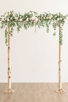 the wedding arch is decorated with greenery and flowers