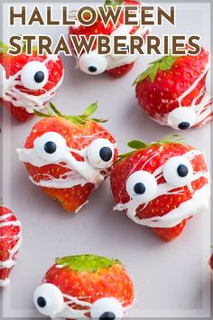 strawberries with googly eyes and white icing on them are arranged in the shape of monsters