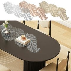 a dining room table with chairs and vases on it in front of wall art