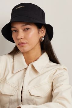 Jacquemus' 'Le Bob' bucket hat has quickly become a brand signature, returning each season in different colors and prints. This one is made from black cotton-canvas and is embellished with glossy logo lettering across the front. Bob Jacquemus, Black Bucket Hat Outfit, Hat Jacquemus, Jacquemus Bucket Hat, Jacquemus Hat, Glossier Logo, Bucket Hat Outfit, Designer Bucket Hats, Black Bucket Hat