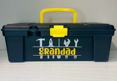 a black and yellow tool box with the words taco grandad on it's lid