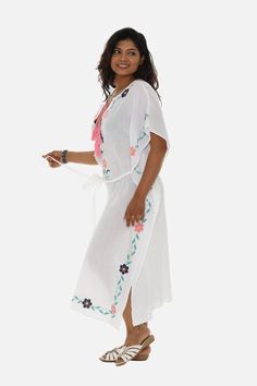 This Kaftan is as delicate and feminine as a midsummer night's dream. The lovely caftan features intricately embroidered floral motifs in soft and feminine pastel hues. The hand-free sleeves and generous neckline complete this bohemian ensemble. Bohemian Kimono With Floral Embroidery For Beach, Spring Embroidered Beachwear Maxi Dress, Folk Style Floral Print Maxi Dress For Beach, White V-neck Kaftan For Spring, White Bohemian Maxi Kimono, White Bohemian Maxi Length Kimono, Bohemian Dresses With Floral Embroidery For Beach Season, Flowy Floral Embroidered Maxi Dress For Vacation, Feminine Floral Embroidered Beach Dress