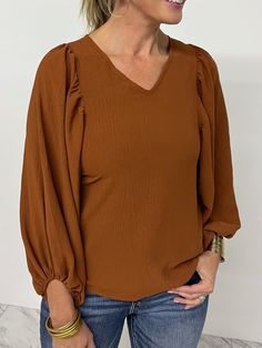 You new favorite top is here... this one has just the right details to make it the one you will be reaching for over and over again!  Mocha colored woven fabric shapes this top featuring a v.neckline and oversized ballon sleeves that are elasticized at the wrists. This style has a relaxed fit, just add denim and cute a Brown V-neck Solid Color Top, Brown Solid Color V-neck Top, Brown Solid Color Blouse For Fall, Brown V-neck Tops For Fall, Chic Brown V-neck Top, Spring Brown Solid Color Blouse, Trendy Brown V-neck Top, Mocha Color, Statement Sleeves