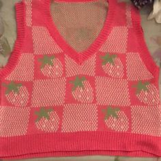 I Am Selling This Pink Strawberry Vest Because I’ve Never Worn It And Probably Never Will So Might As Well Give It To Someone Else. It Is In Great Condition No Rips, Holes, Strings Hanging Out, And The Color Is Very Bright. The Material Is Like A Yarn Material But Not Itchy Nor Uncomfortable It’s Soft And Flexible. The Color Is Pink And It Comes In Only One Size Which Is A M. I Hope Whoever Buys It Enjoys. Strawberry Sweater Vest, Pink V-neck Sweater Vest For Summer, Pink Argyle Knit Vest, Pink Argyle Sweater Vest, Pink Strawberry Cardigan, Halter Top And Skirt, Uniqlo Bags, Slack Pants, Seersucker Pants