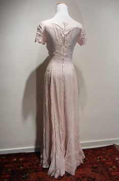 "The quintessential 1930 tea dress. Scalloped bust line and sleeves, fitted bodice, zip back, gorgeous framing of decollette, and a six gore bias cut flare to the skirt. Minor discoloration at edge of neckline in back. And how about those matching gloves that finish the look?! My mannequin has a 36 bust and 24\" waist. Length is 56\" from center neckline / collar to hem. It is fitting my mannequin as though it were made for her. The rib cage tapers to 26 under bust and to the waist to create the Fitted Full-length Maxi Dress For Daywear, Fitted Full Length Maxi Dress For Daywear, Fitted Tea-length Lined Dress, Fitted Tea Length Lined Dresses, Classic Fitted V-neck Vintage Dress, 1950s Fitted Dresses For Vintage Events, Fitted 1950s V-neck Dress, Vintage Event Dresses With Fitted Bodice And Short Sleeves, Classic Fitted Vintage Dress For Vintage Events