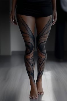 a woman's legs with tattoos on them