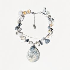 This unique necklace embodies the ideas of reusing materials and creative approach to design. The main accent is the sea shell pendant, which is harmoniously combined with pearls, crystal beads, mother-of-pearl pendants and metal cowries. All the elements of the necklace are connected by stainless steel fittings, which ensures the durability and reliability of the product. This necklace is ideal for creative and stylish people who like to stand out from the crowd. It will be a great addition to Unique Shell Pendant Necklace, Unique Shell-shaped Necklace With Natural Stones, Ocean Elements, Shells And Pearls, Jewelry Mood Board, Treasure Craft, Stylish People, Jewelry Ocean, Sea Necklace