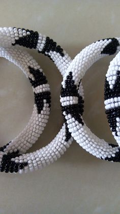 Bracelets | Custom Bracelets | Mother's Gift | Gift Idea | Bangles | Unique Gift | Bracelets For Women | Yoga Bracelets | Daughters Gift These superbly crafted Zulu beaded bracelets are made of fine beads which can be worn in any occasion. Color - White and black. Feel free to send me a convo or e-mail for any clarification. Thank you for visiting... Adjustable Beaded White Bangle, White Beaded Bangle With Round Beads, Adjustable White Beaded Bangle, White Beaded Bracelets With Jubilee Style, White Handmade Round Beads Wristband, Traditional White Stretch Bracelet With Round Beads, White Handmade Wristband With Round Beads, White Bracelets With Round Black Beads, Handmade White Wristband With Round Beads