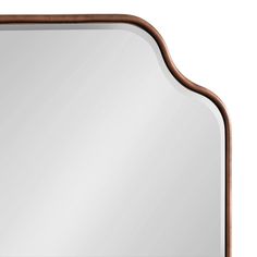 a mirror that is sitting on top of a table with a wooden frame around it