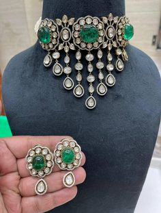 Sabyasachi inspired Emerald Green Victorian Polki and Pearls Indo western Choker Necklace Set with Victorian work Earrings This pretty necklace is sure to take your wedding dressing game a notch higher with much ease. We love to see this one on rich chiffon sarees or classic black angrakha kurtas.  This stunner of a necklace set is meant for royalty and is sure to fetch you compliments in plenty.  Elegant and classic victorian work necklace set with high grade semi precious emerald green tone stones and high grade shell pearls. Sabyasachi inspired choker necklace set with stud earrings is a show stealer. Wear this with anything traditional, a saree, a lehengas or a classic kurta suit.  Made in Silver copper alloy with semi precious emerald green stones. LENGTH Necklace Size - 16 inches. Cl Black Angrakha, Polki Choker Set, Ad Jewellery, Wedding Dressing, Sabyasachi Jewelry, Work Earrings, Unique Wedding Jewelry, Polki Choker, Emerald Green Stone