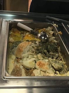 a metal tray filled with food and utensils on top of a stovetop