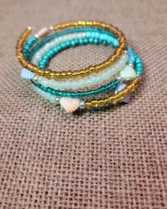 https://shorelineshackusa.etsy.com Beach Wrap Bracelet With Tiny Beads, Beach Friendship Bracelets With Gold Beads, Ocean-inspired Turquoise Beaded Bracelets, Handmade Green Beaded Strand Bracelets, Beach Wrap Bracelet With Spacer Beads, Green Hand Wrapped Beaded Bracelets For Beach, Beach Colorful Beaded Wrap Bracelet, Gold Beaded Bangle Bracelets For Beach, Gold Beaded Bangle Bracelet For Beach