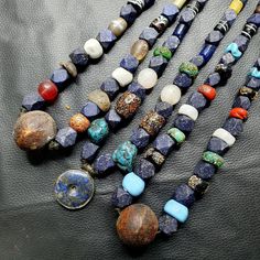 Elevate your jewelry collection with this stunning vintage lot of three Lapis and Glass beaded necklaces. The multicolor gemstone and stone beads add a pop of color to any outfit, while the blue Lapis Lazuli stones are the perfect statement piece. The beaded style is perfect for any occasion, whether you're dressing up or keeping it casual. These necklaces are a must-have for any jewelry lover and make the perfect addition to your collection. The vintage and antique style adds a touch of timeles Vintage Beaded Pendant Necklace With Natural Stones, Vintage Pendant Beaded Necklace With Natural Stones, Blue Spiritual Necklaces With Large Beads, Spiritual Blue Necklaces With Large Beads, Vintage Beaded Pendant Necklace With Gemstone Beads, Traditional Lapis Lazuli Round Bead Necklace, Traditional Lapis Lazuli Bead Necklace, Vintage Natural Stone Beaded Necklaces, Vintage Beaded Necklace For Healing With Natural Stones