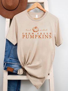 Embrace the rustic charm of autumn with our 'Hand Picked Farm Fresh Pumpkins' Fall Cream Shirt. Crafted from soft and breathable fabric, this shirt blends comfort with seasonal style. Whether you're exploring pumpkin patches, enjoying hayrides, or sipping cider at the orchard, our shirt is your perfect companion for celebrating the harvest season. Key Features: Soft and Breathable Fabric: Made from premium Bella Canvas brand materials, 100% cotton for all-day comfort. Charming Design: Features ' Brown Relaxed Fit Shirt For Fall, Fall Cotton Shirt In Orange, Orange Cotton Shirt For Fall, Rustic Relaxed Fit Tops For Fall, Comfortable Cotton T-shirt For Fall, Relaxed Fit Short Sleeve Shirt For Fall, Soft-washed Comfortable T-shirt For Fall, Soft-washed Comfort Fit T-shirt For Fall, Fall Soft-washed Relaxed Fit Shirt