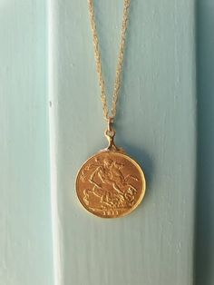 This gold coin necklace was handmade using an old gold Moroccan coin an acquainted of mine inherited from her mother. The pendant can be used on both sides. See last photo for the back side of the coin. The necklace is a quality 14k gold filled chain. The coin pendant necklace is also available in sterling silver. Dimensions: The old Moroccan coin pendent's diameter is 2.1 cm (0.8 inches) The 14k gold necklace is available in multiple lengths. This Gold coin necklace is delicate, unique and beau Antique Gold Round Coin Necklace, Vintage Yellow Gold Round Coin Necklace, Antique Engraved Yellow Gold Coin Necklace, Yellow Gold Medallion Coin Necklace In Brass, Gold Coin Necklace With Round Locket, Gold Coin Pendant Necklace Stamped 14k, Gold Pendant Coin Necklace Stamped 14k, Gold Coin Necklace With 14k Stamp, Gold Round Coin Necklace With Locket