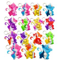 a bunch of colorful key chains that are shaped like elephants and cats with faces on them