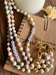 Show your appreciation for the educators in your life with our "Handmade Teacher Pastel Double Beaded Lanyard." Crafted with love and attention to detail, this colorful badge holder not only keeps essentials secure but also adds a touch of personal flair to any outfit. Each lanyard is made using high-quality pastel beads, creating a vibrant and cheerful accessory that stands out in a crowd. Measuring approximately 20 inches in length, our lanyard is the perfect size for holding ID badges, keys, and other small items frequently used by teachers and professionals. The beads are strung on a durable, yet comfortable cord that's designed to withstand daily wear and tear. This user-friendly piece makes it easy to keep your essentials organized and stylish. The "Handmade Teacher Pastel Double Bea Lanyard Crafts, Teacher Jewelry, Pastel Beads, Beaded Lanyard, Teacher Lanyard, Beaded Lanyards, Functional Accessories, Badge Holder, Id Badge