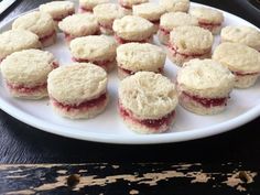 a white plate topped with mini cookies covered in jelly