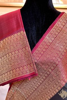 This banarasi inspired stunning kanjivaram saree in kanchana black is handwoven with traditional motifs in gold zari on the body. The borders in deep maroon have traditional motifs like floral, chakras and geometric patterns in gold zari. The grand pallu in deep maroon color mirrors the patterns of the borders in gold zari. Approximate Length 6.5 mtrs (inclusive of blouse length) Approximate weight - 1.5 lbs Approximate Height - 48 - 52" Saree comes with fall, picot and tassels done when applicable. Blouse piece is cut. Kindly Note : The colors you see on your device may vary due to the color reproduction, brightness and resolution of individual devices. If you'd like more clarity before your purchase, please contact our support team. Black Art Silk Pre-draped Saree With Zari Weaving, Traditional Black Pre-draped Saree, Black Pre-draped Saree With Traditional Patterns, Black Bollywood Handloom Pre-draped Saree, Black Silk Handloom Pre-draped Saree, Black Silk Pre-draped Saree With Zari Weaving, Black Pre-draped Saree With Zari Weaving In Art Silk, Black Raw Silk Saree With Cutdana, Black Banarasi Silk Pre-draped Saree With Pallu