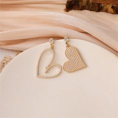 Add a quirky shimmer to your ears in these mismatched heart drop earrings. 1.38'' W x 1.57'' L 1.57'' W x 1.77'' L Goldtone copper / cubic zirconia / pearl Heart Drop Earrings, Cubic Zirconia, Gold Bracelet, Gold Tones, 18k Gold, Gold Necklace, Plating, Copper, Drop Earrings