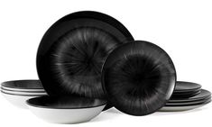 black and white plates stacked on top of each other in front of a white background