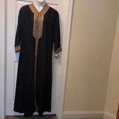 Very Pretty Unbranded Kimono Abaya. Can Be Worn Alone With Buttons Closed And Can Be Paired With Camisole And Leggings Or A Sleeveless Long Dress. The Last Press Button Is Missing. Got From The Store Like That. Very New, Never Worn. Black/Gold Xxl Fitted Black Abaya For Eid, Black Tunic Abaya For Eid, Elegant Black Tunic Thobe, Fitted Long Abaya With Dabka Details, Elegant Black Tunic Abaya, Fitted Long Abaya With Dabka, Traditional Black V-neck Abaya, Black V-neck Abaya For Eid, Black Long Thobe For Eid