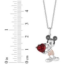 A memorable way to show your love, the necklace represents Mickey & Minnie's playful spirit and loving bond. Crafted in sterling silver, this look showcases Mickey Mouse holding a vivid heart-shaped garnet. His 10K rose gold attire is dotted with diamond accents. Black rhodium details complete the charming design from the Disney Treasures Collection. The pendant suspends along a 17-inch cable chain with 2-inch extender that secures with a spring ring clasp. Exclusively at KAY Jewelers. ©Disney. Disney Silver Jewelry For Anniversary, Disney Jewelry For Mother's Day Gift, Disney Style Jewelry For Mother's Day Gift, Disney Heart-shaped Jewelry Gift, Disney Heart Shaped Jewelry Gift, Disney Jewelry For Valentine's Day Gift, Disney Style Jewelry For Valentine's Day Gift, Disney Silver Jewelry For Valentine's Day, Disney Style Sterling Silver Jewelry Gift