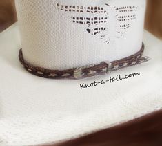 Unique, distinctive and exceptional in all areas: quality- design- Craftsmanship Cowboy hat horse hair hat band! The traditional designed in a cinnamon brown and trimmed in an all natural white horsehair and black horsehair. Everything you want in a Horsehair hat band. ** DISTINCTIVE LOOK ** OUTSTANDING QUALITY ** STETSON PERFECT Brings out your spirit in an exclusive design that is vibrant as your western lifestyle. MEASUREMENTS * longest length 25 inches * shortest length about 15 inches or le Horse Hair Hat Band, Cowboy Hat Band, Cowboy Hat Bands, Horse Hair Jewelry, Black Cowboys, Hair Hat, Hat Bands, Cowboy Horse, Western Lifestyle