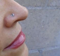 a woman with a nose piercing on her left side