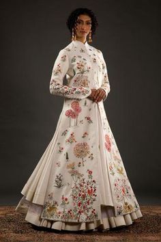 Ivory long jacket with floral, animal motifs in resham and thread embroidery.
Component: 1
Pattern: Embroidered
Type Of Work: Animal,Floral
Neckline: Mandarin
Sleeve Type: Long Sleeves
Fabric: Chanderi Silk, Cotton
Color: Ivory
Other Details: 
Resham and thread work
Floral motifs
Note: Inner dress worn by the model is not for sale
Occasion: Sangeet,Reception - Aza Fashions Luxury Art Silk Traditional Wear With Floral Embroidery, Luxury Traditional Wear With Intricate Embroidery For Celebrations, Luxury Chinon Gown With Intricate Embroidery, Luxury Traditional Wear With Intricate Embroidery, Rohit Bal Collection, Mandarin Collar Jacket, Black Anarkali, Creative Fashion Photography, Fashion Drawing Tutorial