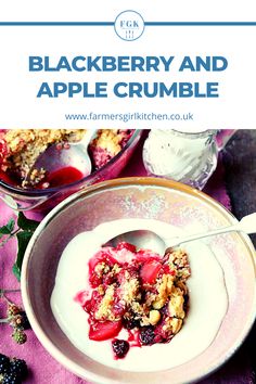 a bowl filled with berries and crumbled in yogurt on top of a pink table cloth