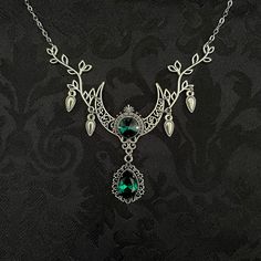 "This enchanting moon elf necklace features richly detailed antiqued silver tone filigree crescent, intricate leafy branches and elegant scroll drop accents. Its captivating design is adorned with dazzling emerald green glass crystals. Decorated portion is 4 1/2\" wide and 2 1/2\" tall in the very center.  Necklace length is adjustable with soldered stainless steel cable chain, lobster clasp and extender. If you would like a different length, please send us a message. Matching headpiece, pendant and earrings are listed separately in our store. If you don't see items with a color you want, feel free to ask about availability." Elf Necklace, Raw Carnelian, Moon Elf, Elven Jewelry, Carnelian Necklace, Filigree Necklaces, Choker Pendant, Crescent Moon Necklace, Moon Goddess