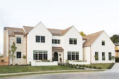 a large white house sitting on the side of a road