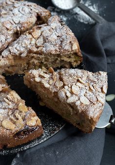 a cake that has been cut into pieces and is on a plate with a spoon