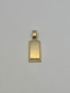 This stunning handmade 14K gold brick pendant resembles a gold bar straight out of the gold reserves. This high quality piece is created through a tedious process. It pairs perfectly with any chain and has a well sized bail. The semi-solid 3D design keeps the cost down while still maintaining a nice weight. This is our medium sized brick for those who prefers a slightly more subtle look and design.  * 100% 14K Yellow, White or Rose Gold * 3D Style  * Semi-solid design  * Height WITH bail about 1 Gold Jewelry With Polished Finish And Rectangular Stone, Gold Jewelry With Rectangular Polished Stone, Gold Bar Pendant, Gold Reserve, Jewelry Post, Bar Pendant, Geometric Pendant, Pendant Gold, Gold Bar