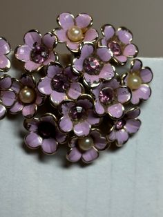 Vintage goldtone enamel clip flower earrings.  No maker.  Flowers are riveted.  Flower centers are faux pearls and purple rhinestones.  For the size (1.5 inches) they are light weight. Vintage Purple Flower Earrings, Vintage Purple Flower-shaped Jewelry, Vintage Purple Flower Jewelry, Flower Center, Purple Rhinestone, Flower Earrings, Faux Pearl, Clip On Earrings, Violet