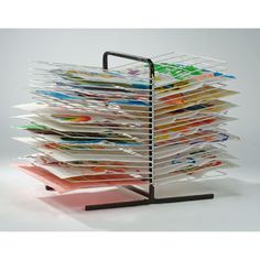 a stack of magazines sitting on top of a metal stand