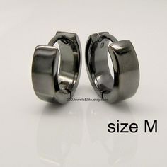 Men's medium hoop earrings in size M. These huggie hoops are 12mm in diameter and 3mm wide. The earrings have a polished shiny finish and are plated in black gold and have a charcoal grey color. We make various sizes in this style https://www.etsy.com/listing/60279626/sterling-silver-earrings-black-gold?ref=related-3 SPECIFICATION Base metal: Recyclable fine 925 Sterling Silver Outer layer: Black gold, polished finish, charcoal grey Width: 3mm Inner Diameter : 9mm, medium Outer Diameter: 12mm Ea