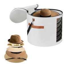 several hats are stacked on top of each other and one hat is attached to the wall