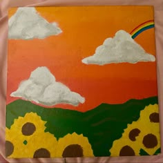 a painting with clouds and sunflowers painted on it