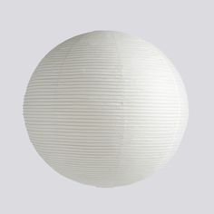 a round white paper lantern hanging from the ceiling