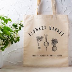 You'll have the cutest bag at the farmers market this weekend with this cute market tote. The farmers market tote bag in natural cotton canvas features root veggies and a cute vintage aesthetic perfect for carrying your veggies and artisan farmers market finds. Plus, when you use the farmer market tote, you're not using a plastic bag! Shop small and local and store all your great stuff in this cute veggie tote bag.  +100% cotton canvas +Durable Heavy fabric +Size 15" x 16" +Printed on front side Organic Tote Bag For Gifts, Eco-friendly Tote Bags For Grocery Shopping, Eco-friendly Cotton Bags For Farmers Market, Eco-friendly Tote Bags For Grocery, Reusable Organic Grocery Bags, Organic Reusable Grocery Bags, Organic Tote Bag For Shopping, Organic Style Tote Bag For Shopping, Cute Vintage Aesthetic