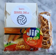 some snacks are sitting on the counter top next to a package of bread and chips