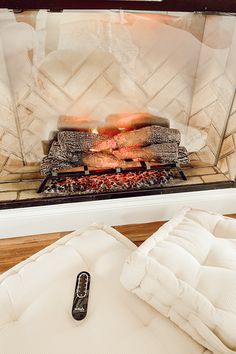 an oven with food cooking inside of it on top of a wooden floor next to a mattress