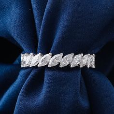 an image of a diamond ring on a blue cloth