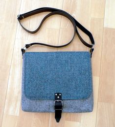 "Gray tweed crossbody bag, teal shoulder bag, gender neutral bag, pocketbook, British wool tweed bag with leather starp and buckle Made from Yorkshire British wool tweed, this bag has lots of structure to create a strong and sturdy bag. It features a large over flap with a leather buckle fastener, a small base gusset to create extra room and a 1\" wide leather adjustable shoulder strap with silver nickel bag hardware. Inside the bag is fully lined in linen and features a large slip pocket and a Womens Weekender Bag, Tweed Purse, Tweed Handbag, Neutral Bag, Tan Leather Bag, Tweed Bag, Crafted Bag, Bag Hardware, Carpet Bag